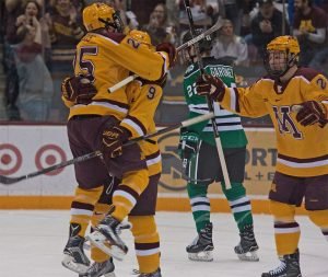 Kloos and Sheehy celebrate with Szmatula as he puts Minnesota cup 1-0