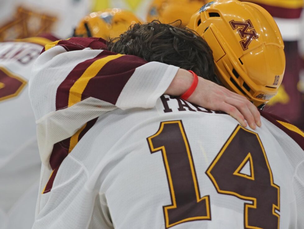 Mason Nevers embraces Brock Faber after the Gophers are beaten in overtime. Photo by Craig Cotner