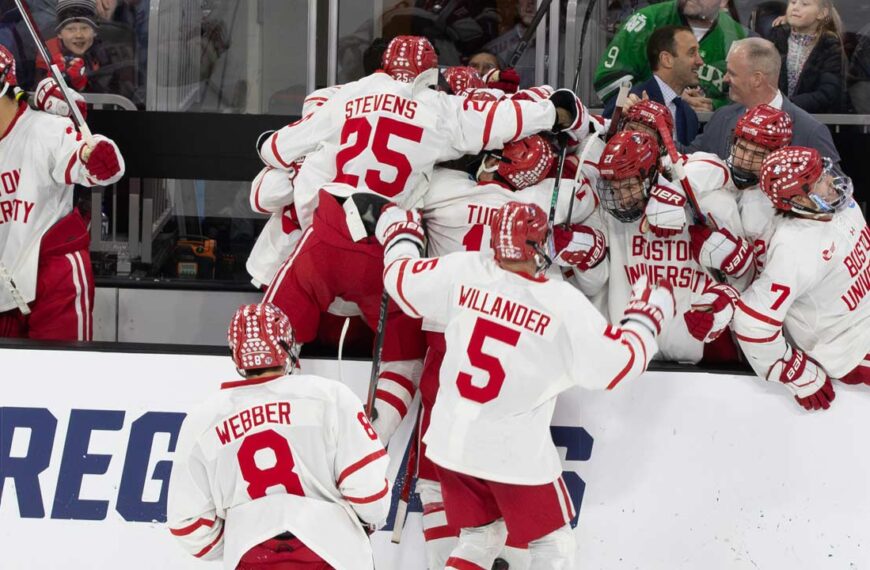 Boston University celebrates after getting an empty net goal to seal the victory. Photo by Craig Cotner.