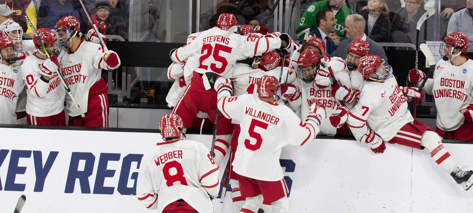 Boston University celebrates after getting an empty net goal to seal the victory. Photo by Craig Cotner.