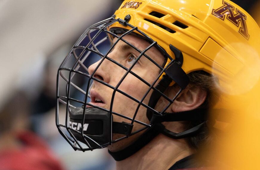 Rhett Pitlick looking up at the scoreboard from the Minnesota bench.